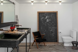 A vintage Beni Ourain rug from Mehraban sits in the bathroom.