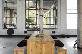 The seating area includes lighting by Apparatus and black candles from Cire Trudon. The table and benches are custom-made from a very rare and heavy reclaimed oak. The benches are lined with Icelandic sheepskin throws.