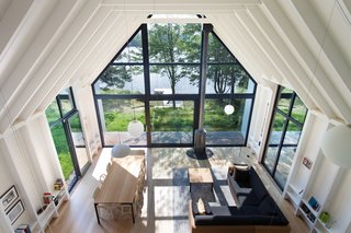 Floor-to-ceiling glass windows seamlessly connect the indoor spaces to the outdoors.