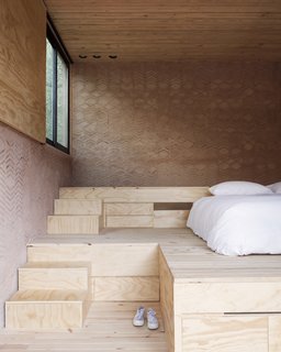 A raised platform allows for storage underneath the stairs.