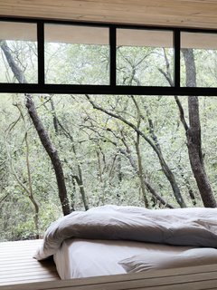 A peek at one of the bedrooms that looks out to the tree tops.