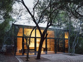 The living lounge, dining area, and kitchen are located within the larger of the two volumes.