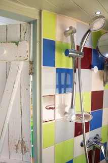 A shower is located in the wet room.