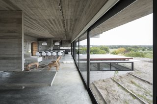 This Stacked Concrete Home Is Not Your Typical Golf Course Dwelling - Photo 13 of 17 - Layered concrete walls and ceilings add a raw masculinity to the interiors.
