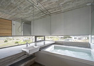 This Stacked Concrete Home Is Not Your Typical Golf Course Dwelling - Photo 6 of 17 - There is also a hot tub that looks out to views of the surrounding neighborhood.