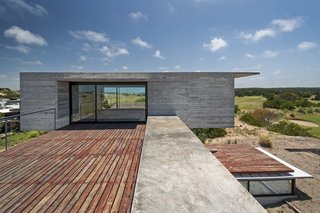 This Stacked Concrete Home Is Not Your Typical Golf Course Dwelling - Photo 12 of 17 - The large viewing terraces allow the outdoors to play a major part in the home's design.