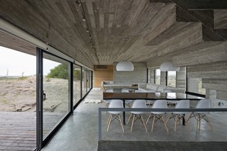 This Stacked Concrete Home Is Not Your Typical Golf Course Dwelling - Photo 8 of 17 - The dining area connects to an expansive viewing terrace.