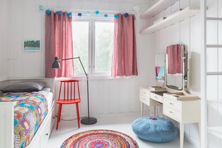 Colorful bed spreads and rugs make this a cool bedroom for kids.
