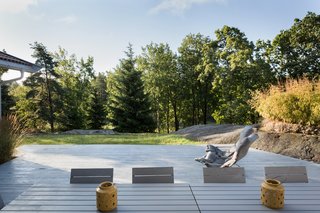 The large outdoor terrace is surrounded by trees.
