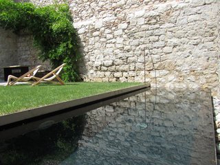 An old cistern found on the original site is now a black concrete pool.