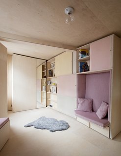 The cabinet doors slide to reveal book shelves.