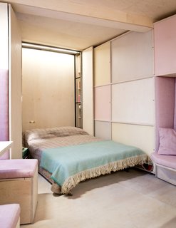 A vertical Murphy bed fits perfectly into a narrow space in this triangular apartment.