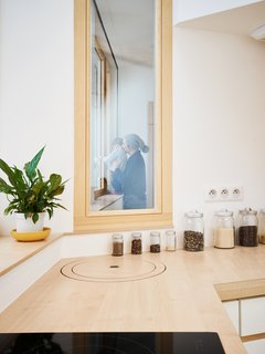 Before and After: A Renovated Artist's Studio Is Now an Airy, Efficient Home - Photo 10 of 16 - A narrow window creates a visual connection between the bedroom and kitchen.