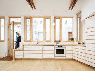 Before and After: A Renovated Artist's Studio Is Now an Airy, Efficient Home - Photo 7 of 16 - The white cabinetry with beech wood details adds a touch of Zen to the kitchen.