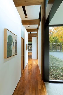 Artwork hangs along the walls of the hallway that connect the wings.