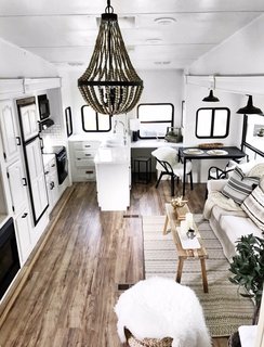 10 Things You Should Know Before Moving Into a Tiny Home - Photo 13 of 20 - Wood details and a simple, white-and-black color scheme give the RV's interior a bright, modern, Scandinavian feel.