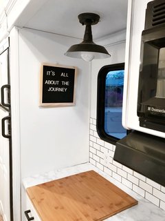 The kitchen workstation faces a window, allowing for ample amounts of natural light.