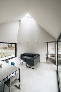 This Forest Retreat Is a Modern Take on the Traditional Estonian Hut - Photo 9 of 12 - Fully glazed walls on two sides and a triangular skylight allow light to permeate the living areas.