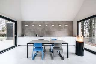 This Forest Retreat Is a Modern Take on the Traditional Estonian Hut - Photo 6 of 12 - The simple, fuss-free kitchen and dining area flows into the living lounge.