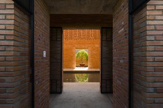 Light and Shadow Help Shape This Modern Brick House in Vietnam - Photo 14 of 15 - A pool in the middle of the house conveys balance in accordance with yin and yang principles.