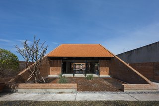 Light and Shadow Help Shape This Modern Brick House in Vietnam - Photo 2 of 15 - Clay brick flooring in the front yard helps drain rainwater and reduce heat.