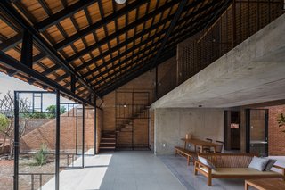 Light and Shadow Help Shape This Modern Brick House in Vietnam - Photo 12 of 15 - Staircases are placed at either end of the residence.