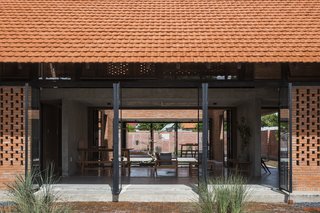 Light and Shadow Help Shape This Modern Brick House in Vietnam - Photo 6 of 15 - A buffer space between the living area and the front yard creates a safe play area for the kids.