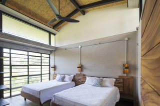 A Concrete Abode Becomes a Surfer's Paradise - Photo 8 of 23 - Floor-to-ceiling glass windows help to bring the green outdoors into the bedroom.