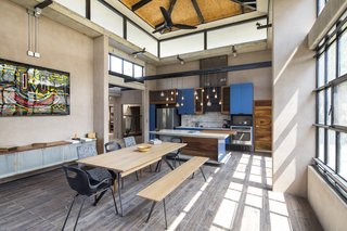 A Concrete Abode Becomes a Surfer's Paradise - Photo 5 of 23 - Bright blue kitchen cabinets reflect the blue of the sea close by.