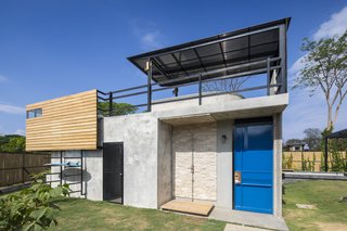 A Concrete Abode Becomes a Surfer's Paradise - Photo 12 of 23 - A smaller rectangular building between the two blocks is used as a pool house, as well as a storage area for surfing gear. The roof deck features a pergola-shaded plunge pool.