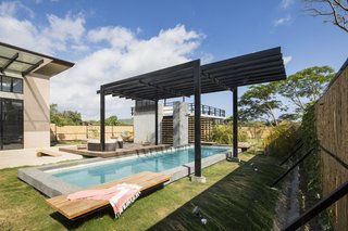 A Concrete Abode Becomes a Surfer's Paradise - Photo 17 of 23 - The pergola keeps swimmers cool on hot days.
