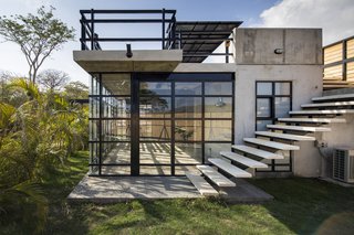 A Concrete Abode Becomes a Surfer's Paradise - Photo 14 of 23 - The windows are customized to control the light and air flow in different parts of the property.