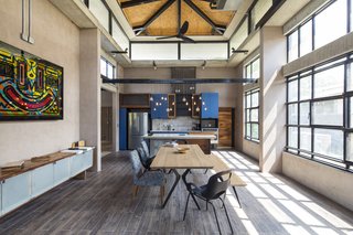 A Concrete Abode Becomes a Surfer's Paradise - Photo 4 of 23 - The dining and kitchen area encompass a bright and airy vibe.
