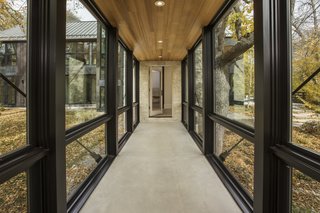 A fully glazed corridor allows the owner to enjoy the autumn foliage outdoors.