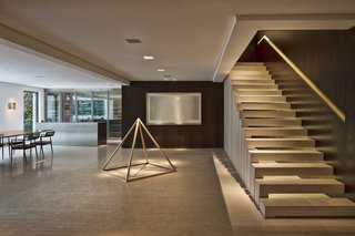 The living room, dining area, and kitchen are located on the lower level.