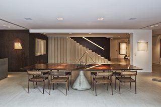 The color and sculptural form of the dining table also complements the art on the walls.