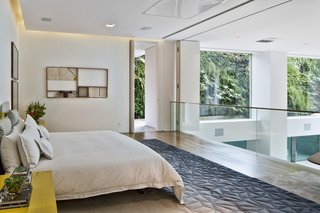 The fitness room and the master bedroom lead out to a veranda, which the owners can use to access the pool.