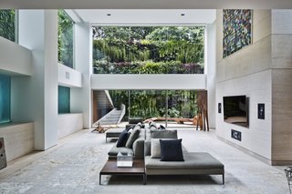 With expansive glass walls, the surrounding outdoor setting appears a stunning work of art.