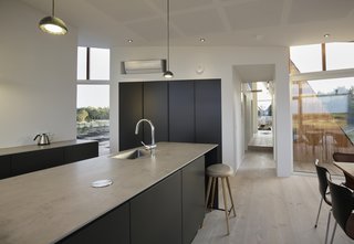 A corridor leads from the living area to the bedroom.
