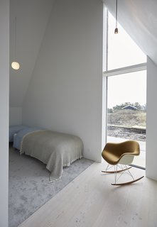 A full-height window frames striking views of the dunes.