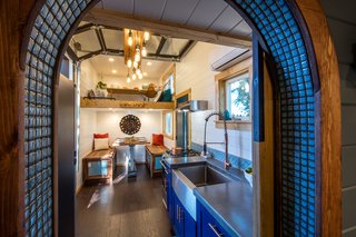 A view of the kitchen, dining area, and loft lounge from the bathroom.