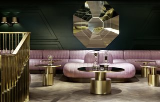 Inspired by Sea Containers House—a landmark building on the south bank of the River Thames—the bar is furnished with leather banquettes in cool lavender shades, velour lounge chairs, mirrored tables, and gold and brass accents.