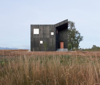 "The geometry of the roof transforms from a typical pitched gable on the short northeast end of the façade, to a flat roof on the opposite end of the southwest facade," says cofounder Javier Ampuero Ernst. "This transition creates a dynamic arrangement of folding roof planes."
