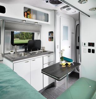 The trailer's fiberglass structure was styled by automotive designer Bryan Thompson, who had previously worked on Airstream's Basecamp model. The semi-monocoque fiberglass structure features an expansive, low-stance windshield.
