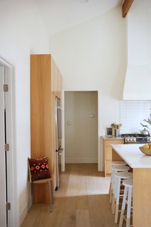 Stained hardwood floors complement the stained beech wood cabinets.