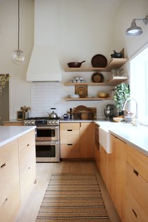 When Portland–based Suraya and Jason Barbee were ready to give their kitchen a fresh makeover, they hired His Builders—a small, family-run firm headed by brothers Owen and Nathan Burkholder—to help them carry out the remodel. After Suraya shared her vision for the kitchen, the team decided the best way to achieve her goals was to move the room to the original dining space, which had a higher ceiling. By moving the kitchen, the team was able to remove a wall, which created the desired open, airy feel the couple longed for. 
