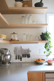 These modern and durable shelves create a sense of openness in the kitcen.
