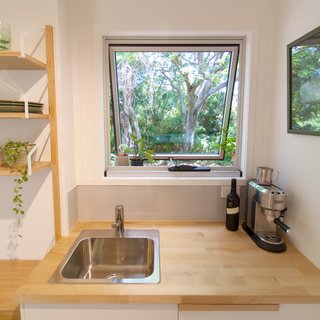 This Midcentury-Inspired Tiny House Radiates Clever Design - Photo 9 of 10 - By resisting the urge to fill every inch of the tiny house, the trailer retains a spacious feel. 