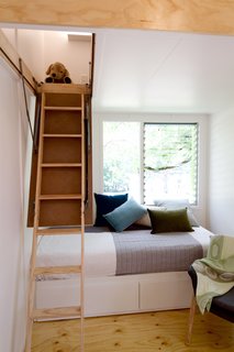 This Midcentury-Inspired Tiny House Radiates Clever Design - Photo 8 of 10 - Thanks to the retractable ladder and no built-in furniture or cabinetry in the main living area, a range of layouts and arrangements are possible. 