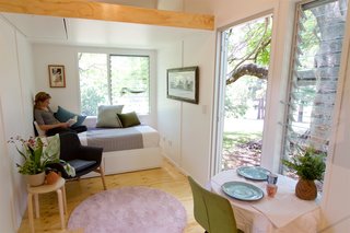 This Midcentury-Inspired Tiny House Radiates Clever Design - Photo 2 of 10 - The sleeping loft can be accessed with a convenient retractable ladder with multiple grab-points that disappear into the ceiling when not in use.